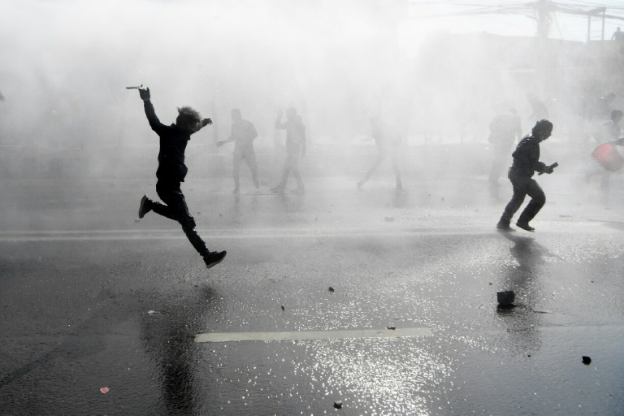 Police personnel use water cannon to disperse demonstrators in Kathmandu against a project of the US Millennium Challenge Corporation in February 2022