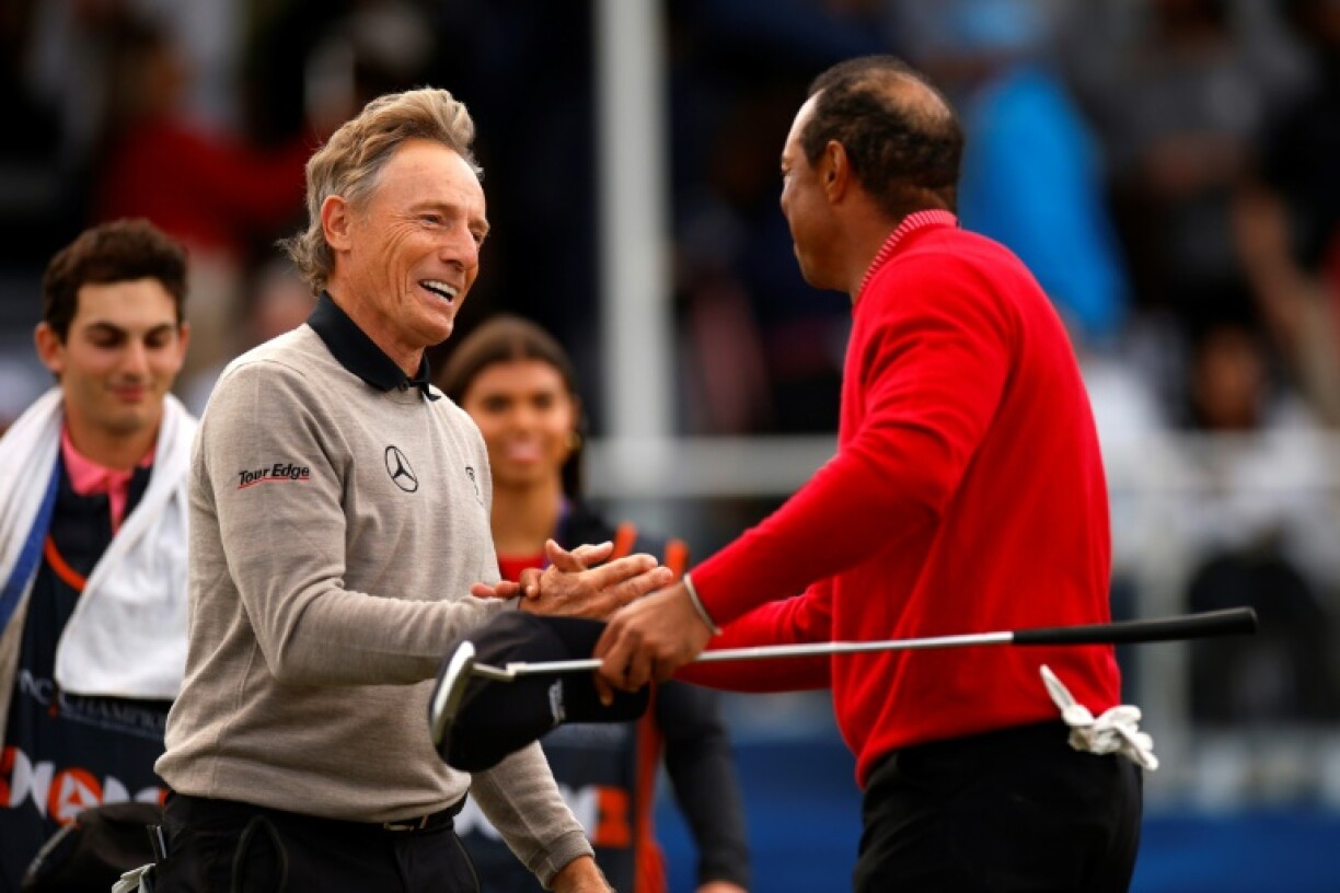 Tiger Woods and Bernhard Langer shake hands after Team Langer's victory over Team Woods in the PNC Championship family golf event