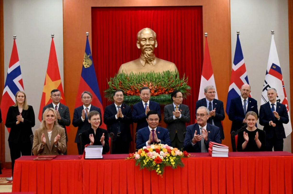 Vietnam's President To Lam (back 5th R) and delegates applaud with Iceland's Foreign Minister Thorgerdur Katrin Gunnarsdottir (L), Liechtenstein Prime Minister Brigitte Haas (2-L), Vietnam's Minister of Industry and Trade Le Manh Hung (C), Switzerland's President Guy Parmelin (2-R), State Secretary at the Norwegian Ministry of Foreign Affairs Astrid Bergmal (R) in Hanoi on October 18, 2026