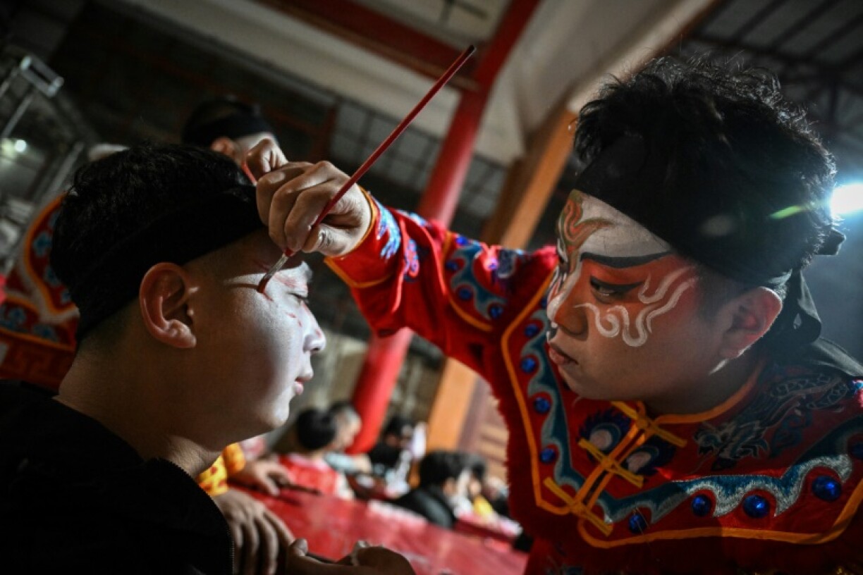 The dancers are clad in intricate robes and headdresses of soldiers or mythological heroes