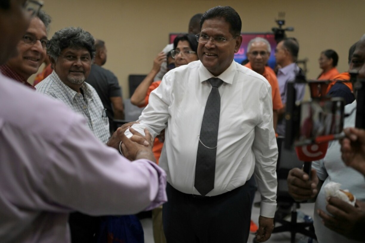 Suriname's President Chandrikapersad Santokhi greets supporters after a campaign rally in Paramaribo on May 22, 2025.