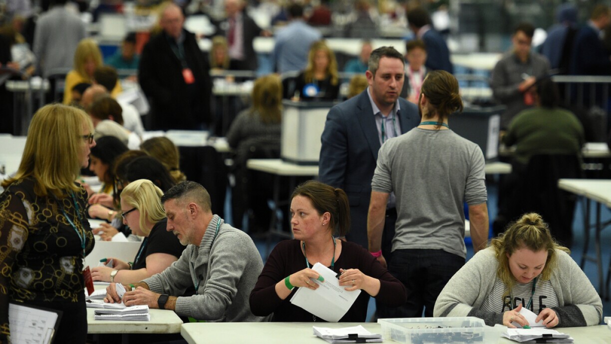 Count staff sort ballot papers in the count centre in Uxbridge, where Britain's Prime Minister and Conservative leader Boris Johnson hopes to hold his seat, in west London, on December 12, 2019.