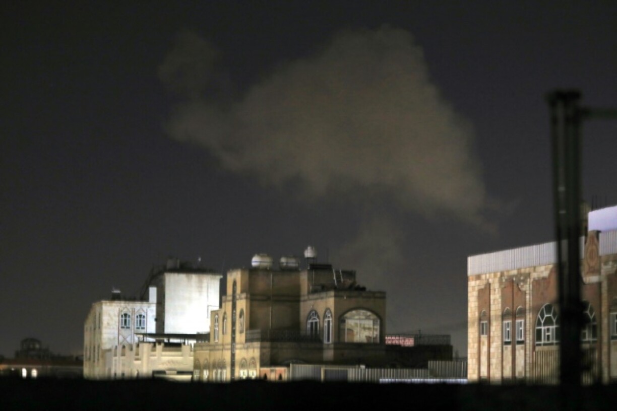 Smoke billows skywards after an air strike on Yemen's capital Sanaa late on December 27