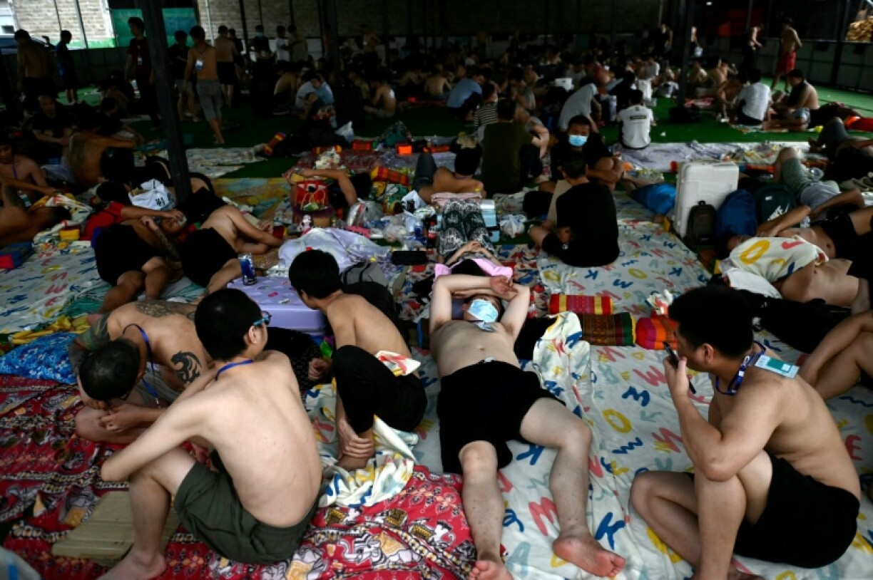 Released scam centre workers wait to be brought into Thailand during the crackdown in February