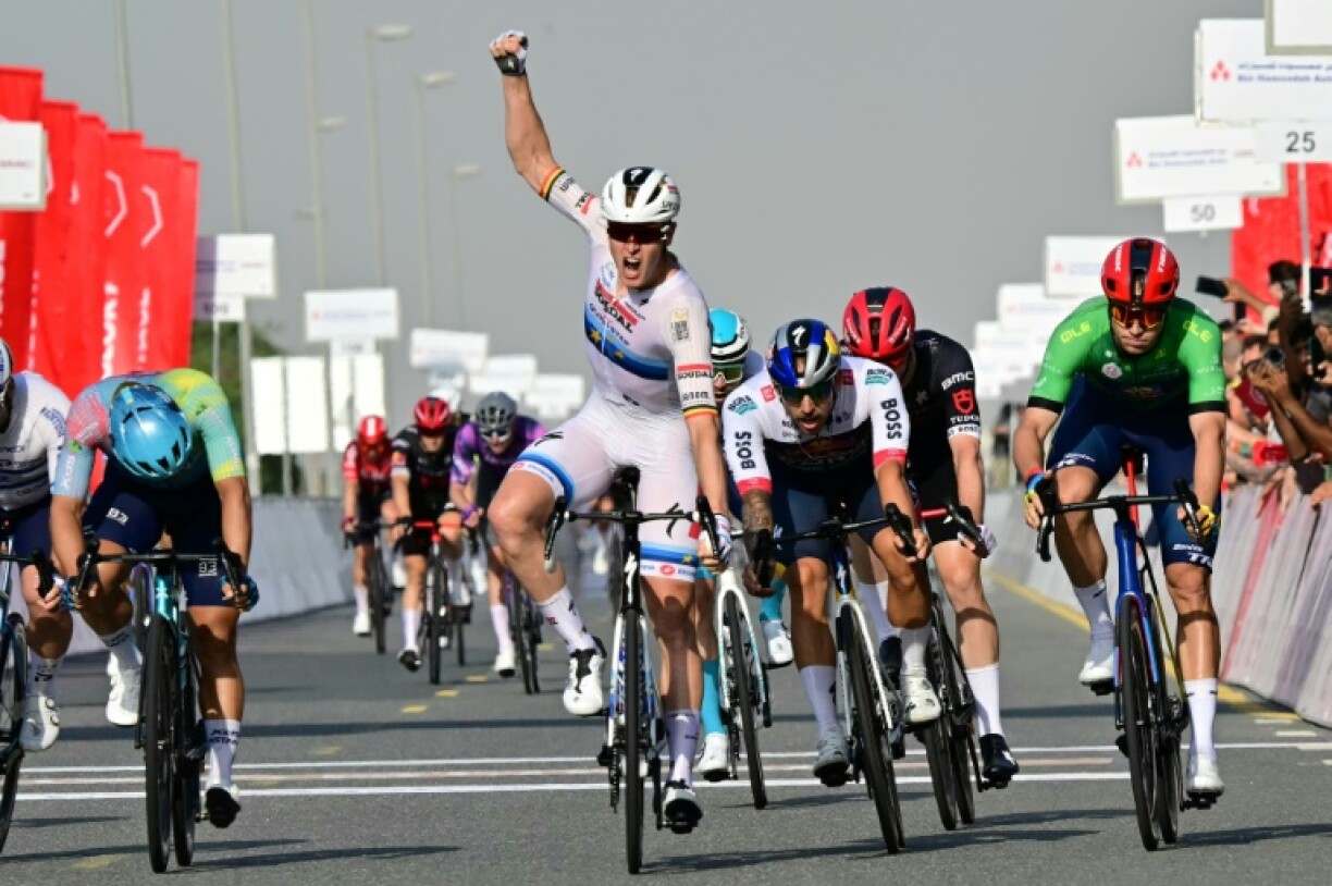 Tim Merlier raises his fist to celebrate a stage victory after two near misses in the UAE Tour