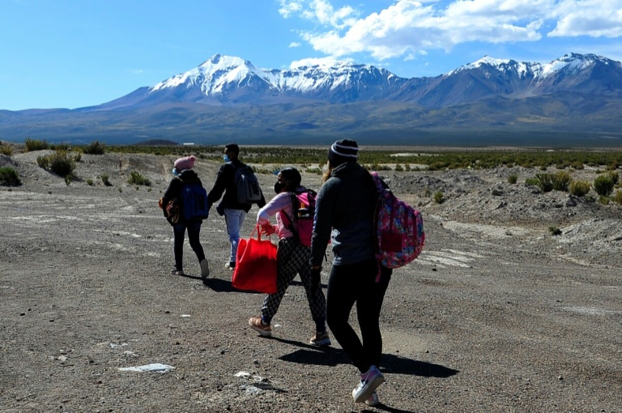 Venezuelan migrants walk near Pisiga, Bolivia, on their way to Colchane, Chile