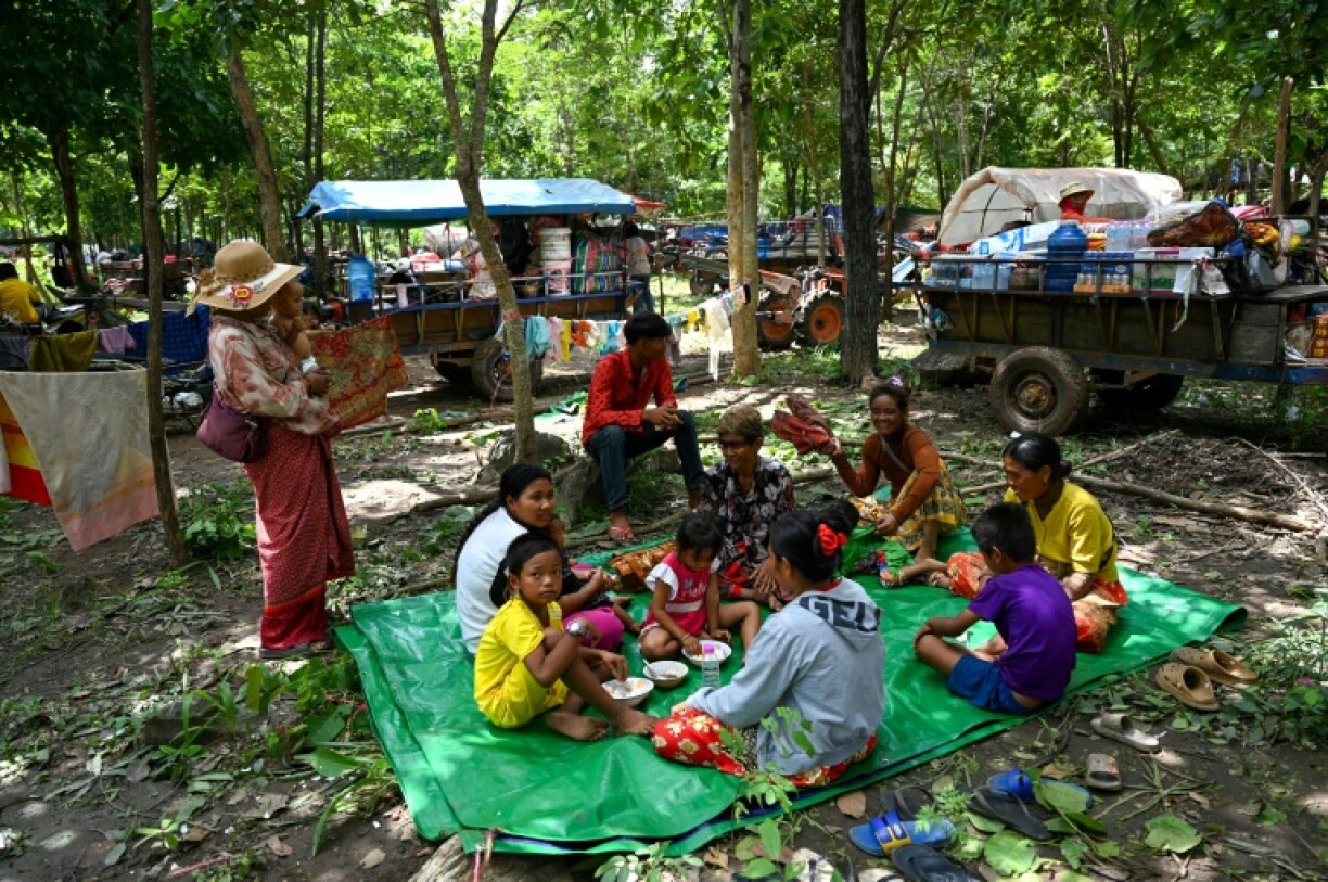 People who fled their homes near the Cambodia-Thailand border rest on the grounds of a pagoda in Oddar Meanchey province