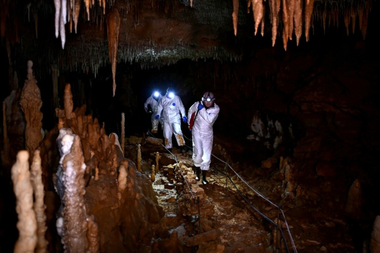 Lighting the way with headlamps, visitors cross vast galleries of stalactites and stalagmites, following the same path as Marc Delluc, the late amateur speleologist who discovered the cave in 2000