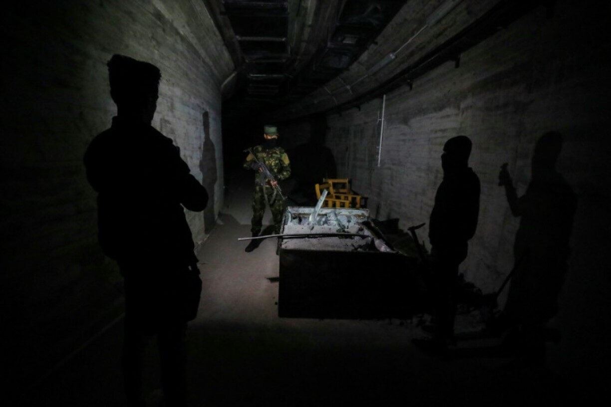 Syria security force members guard a tunnel in the complex from which ousted president Bashar al-Assad's feared younger brother Maher controlled his empire