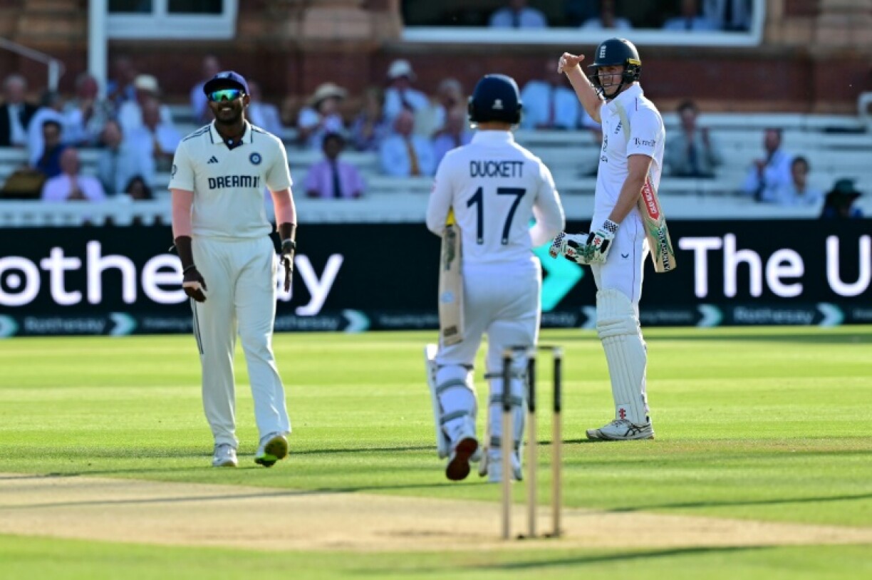 England's Zak Crawley (R) calls for medical attention in the third Test against India at Lord's