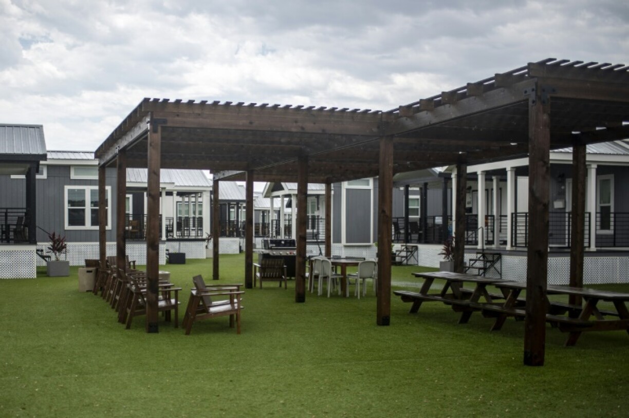 Prefabricated houses painted black, white, and gray are home to some 500 residents and more are being built