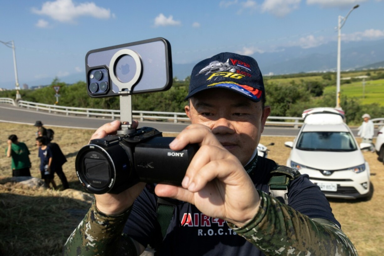 An aviation enthusiast waits outside Chihhang Air Base for the arrival of Taiwan's newly purchased F-16V fighter jets