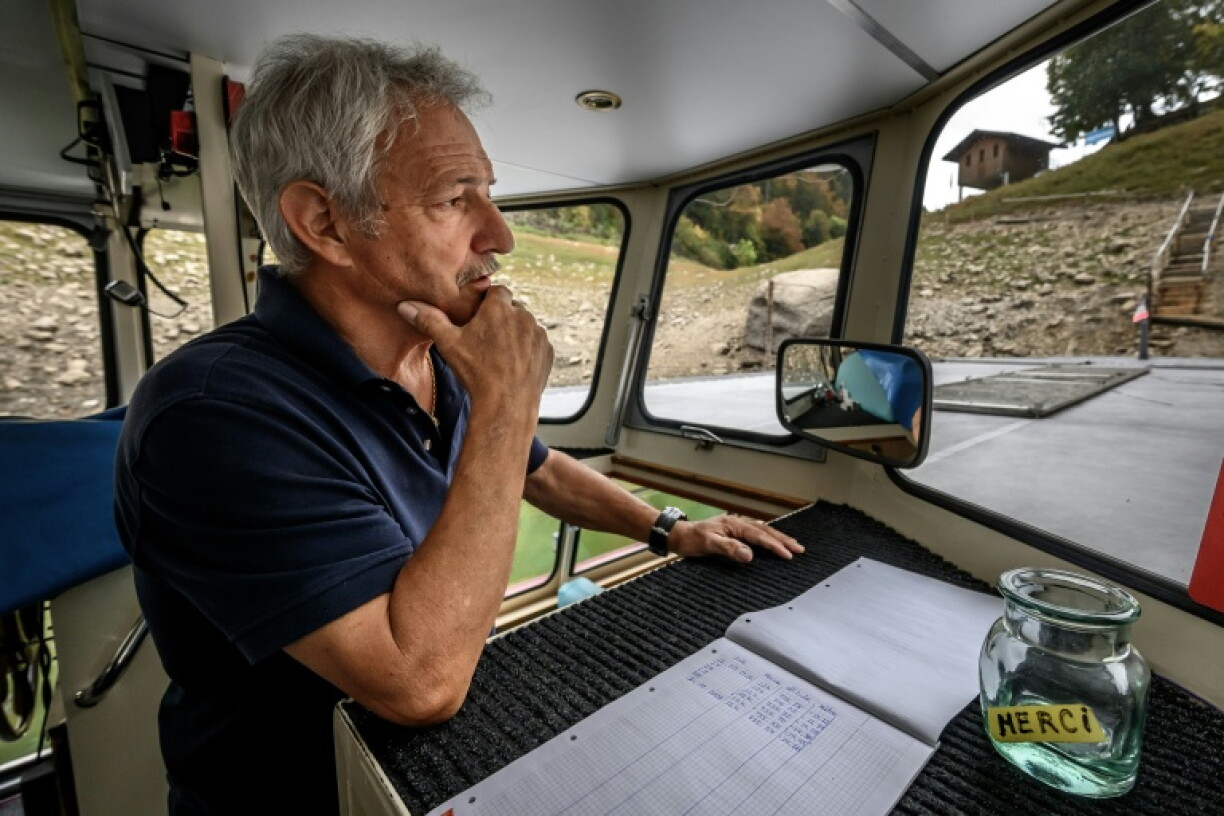 Skipper Yvan Durig records the water level on a daily basis at the remaining basin at the northern end of the lake