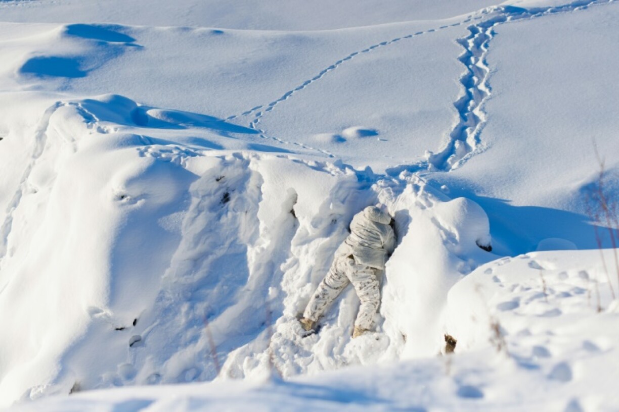 A Canadian sailor peers over a ridge during Operation Nanook, the Canadian Armed Forces' annual Arctic training exercise, in Inuvik, Canada in February