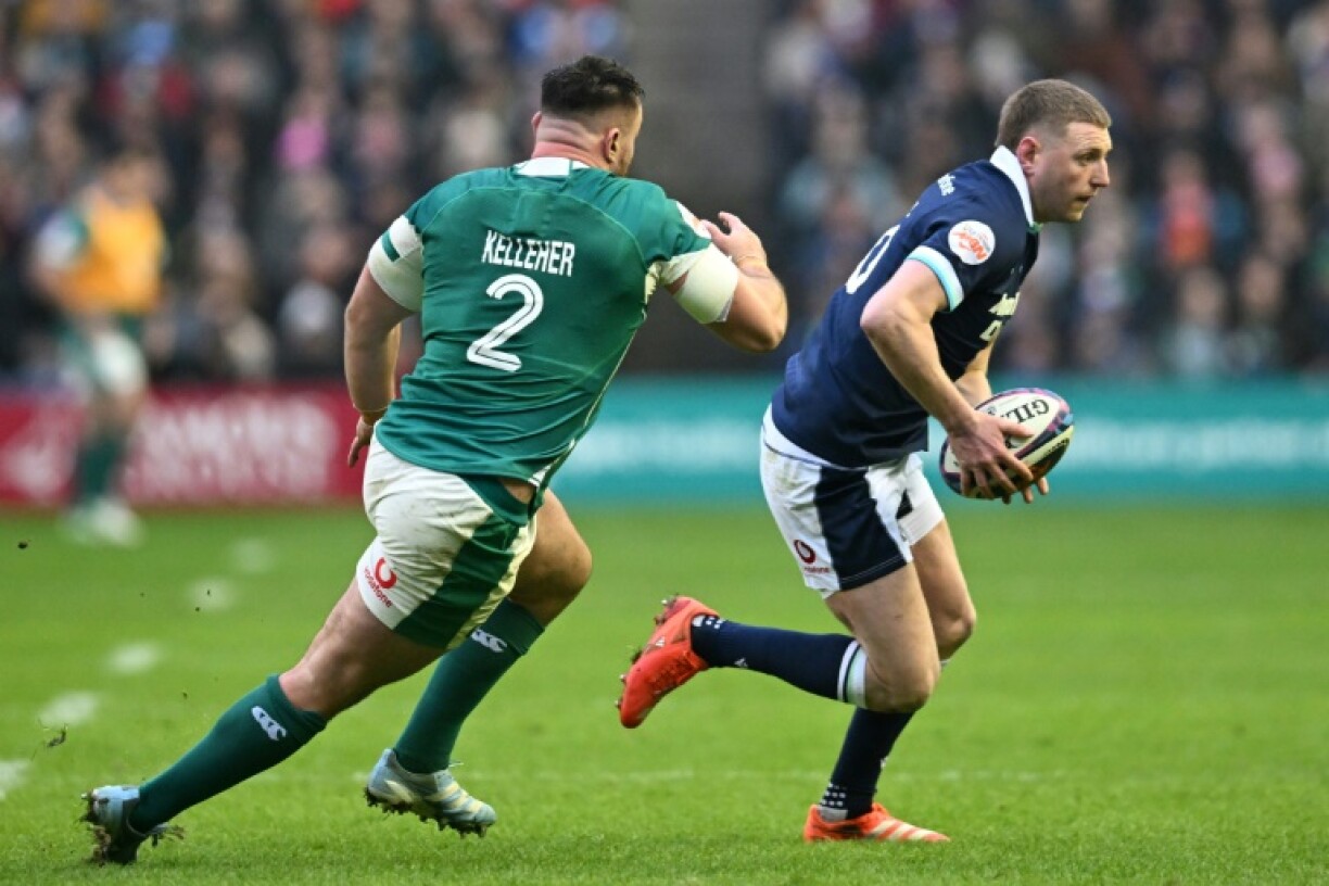 Running man: Fly-half Finn Russell (R) is pursued by hooker Ronan Kelleher during Scotland's 32-18 Six Nations loss to Ireland at Murrayfield