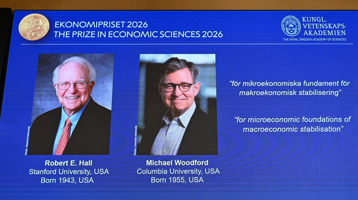 US macroeconomists Robert E Hall and Michael Woodford are seen on a screen as they are announced as the laureates of the 2026 Sveriges Riksbank Prize in Economic Sciences in Memory of Alfred Nobel at the Royal Swedish Academy of Sciences in Stockholm on October 12, 2026. (Photo by Jonathan Nackstrand / AFP)