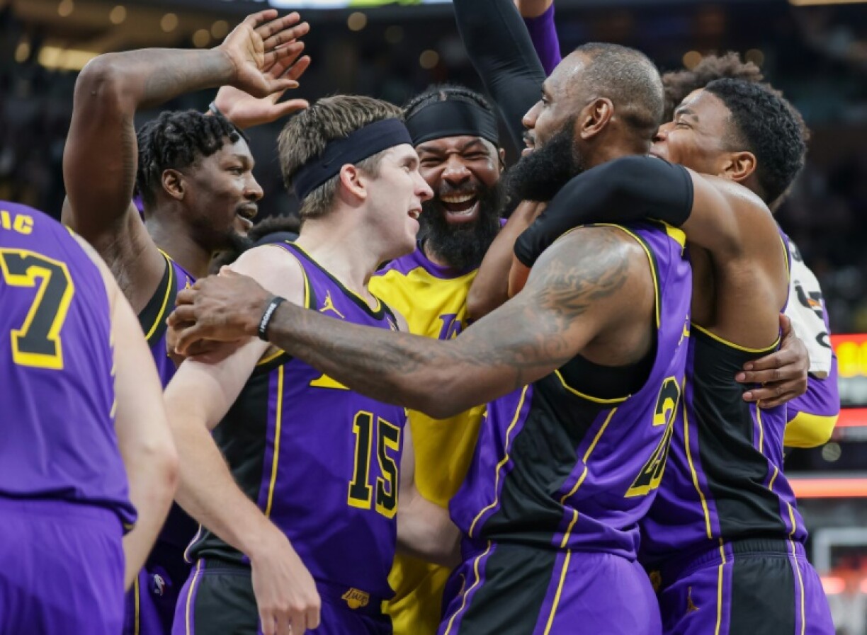 LeBron James is mobbed by his Los Angeles Lakers team-mates after a buzzer-beating winner in a victory over the Indiana Pacers