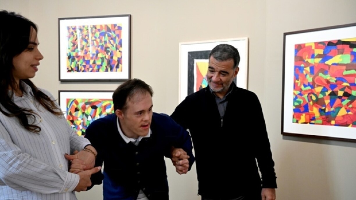 Rodrigo Salgado (au centre), artiste porteur de trisomie 21, dans sa première exposition