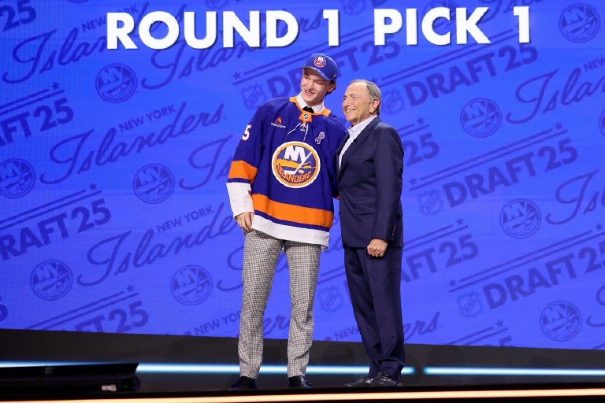 Matthew Schaefer poses with NHL commissioner Gary Bettman after he was drafted first overall in the NHL draft by the New York Islanders
