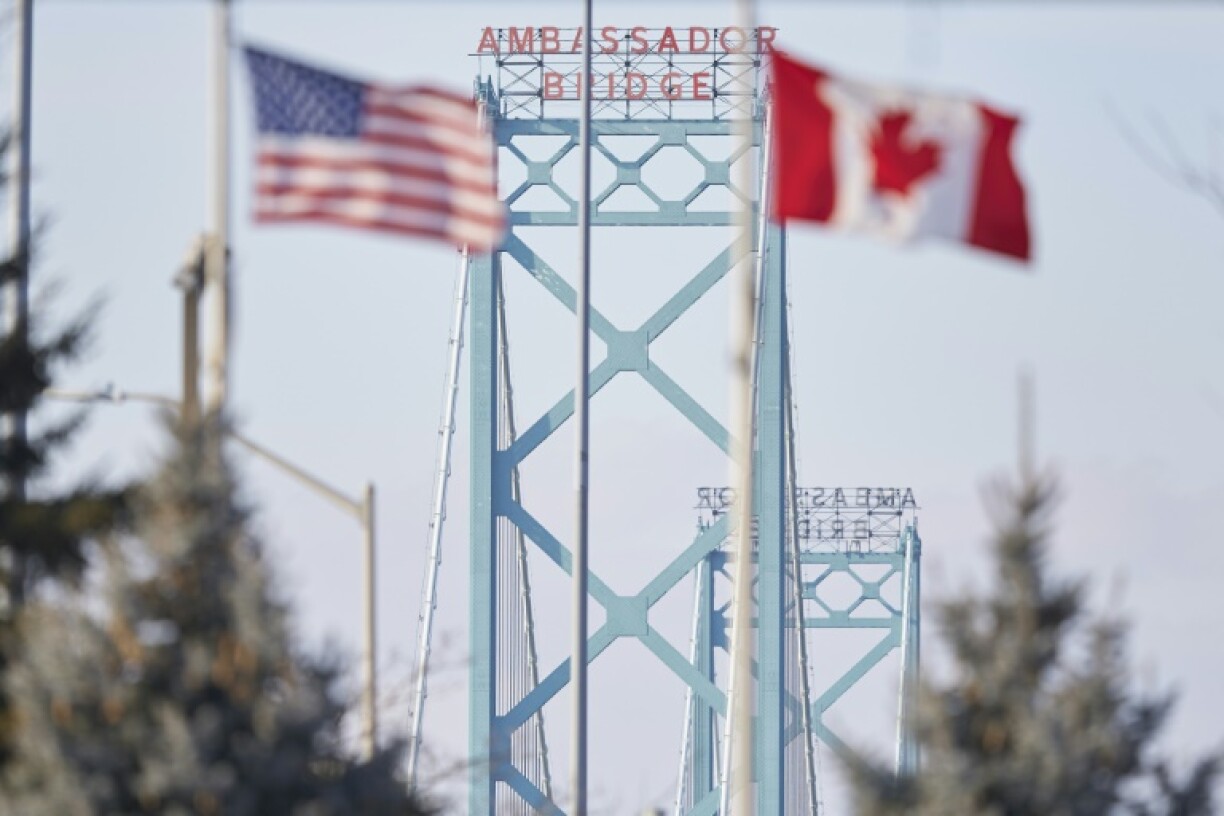 The American and Canadian flags fly at the Ambassador Bridge border crossing in Windsor, Ontario, Canada