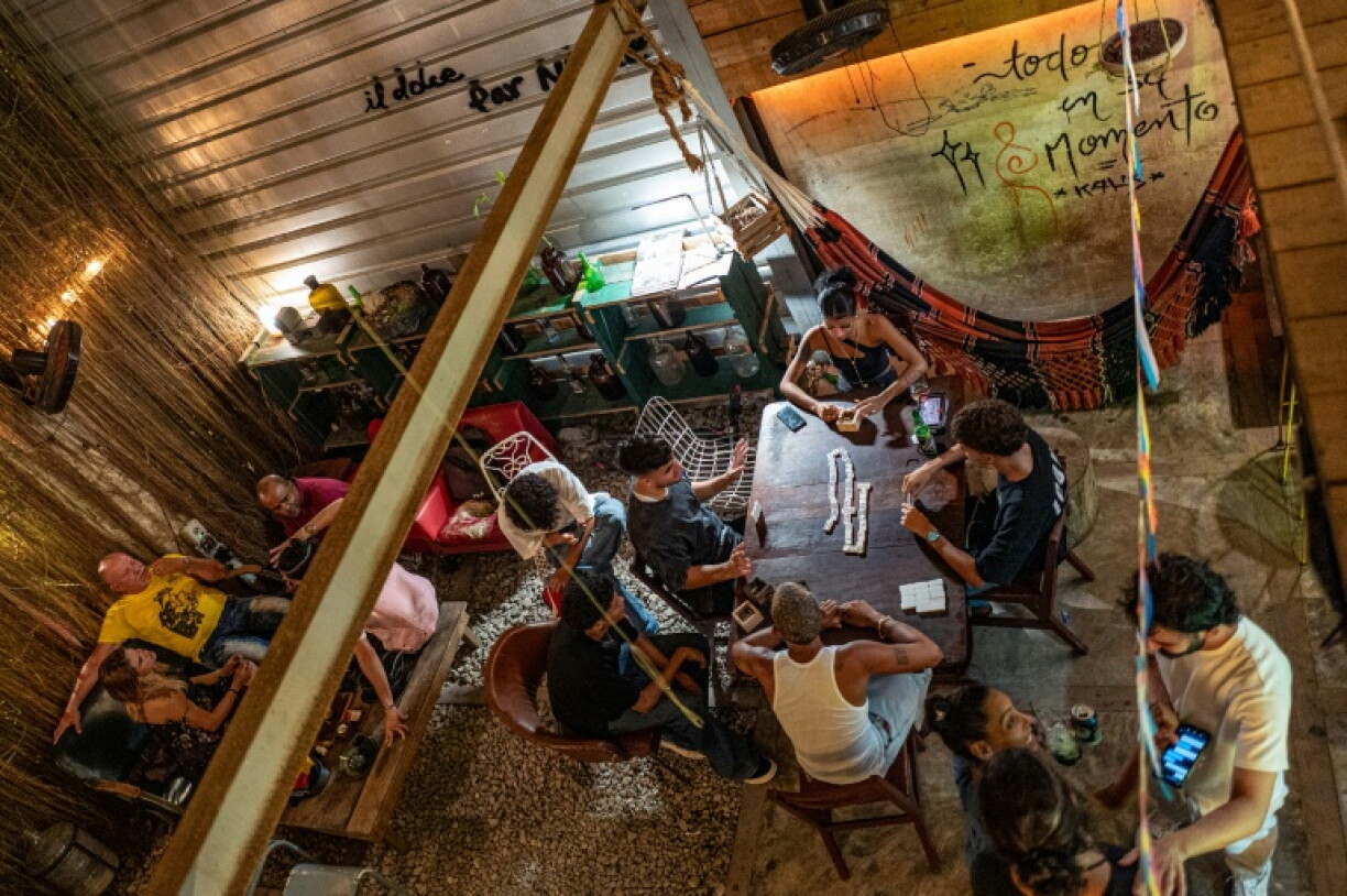 Young Cubans have taken to playing dominoes to pass the hours