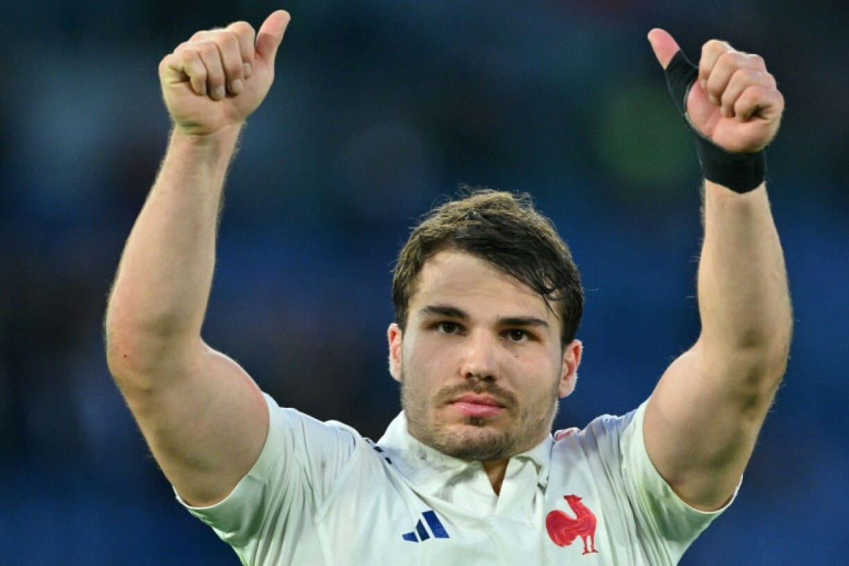 Twice as good: France scrum-half Antoine Dupont, who scored two tries, celebrates victory in Italy