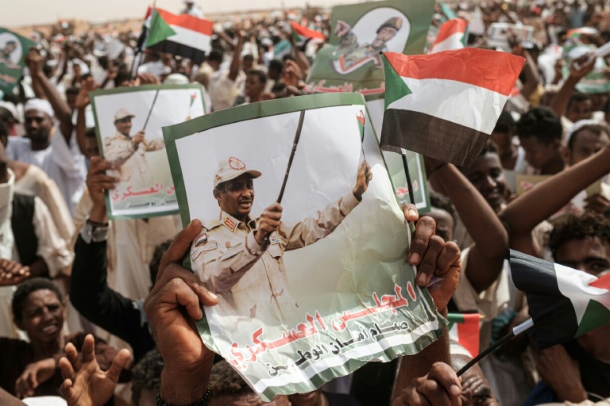Supporters hold portraits of Mohamed Hamdan Daglo during a rally in 2019