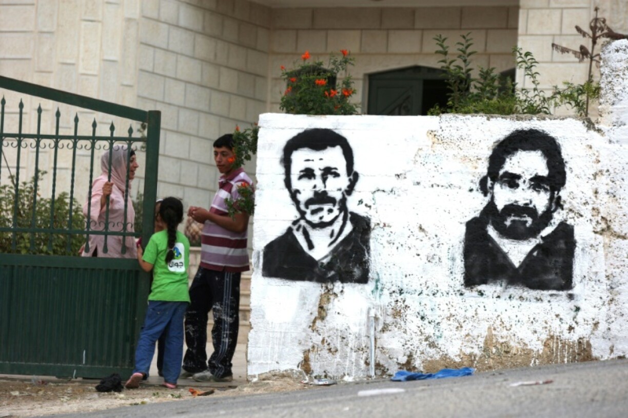 Graffiti of Nael Barghouti (L) and another long-serving Israeli prisoner Fakhri Barghouti, in the occupied West Bank village of Kubar on October 16, 2011