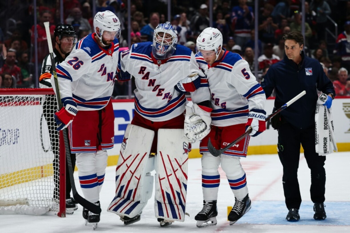 New York Rangers goaltender Igor Shesterkin, at center being helped off the ice by teammates in a loss at Washington, will miss the remainder of the NHL season with an injury, the team announced