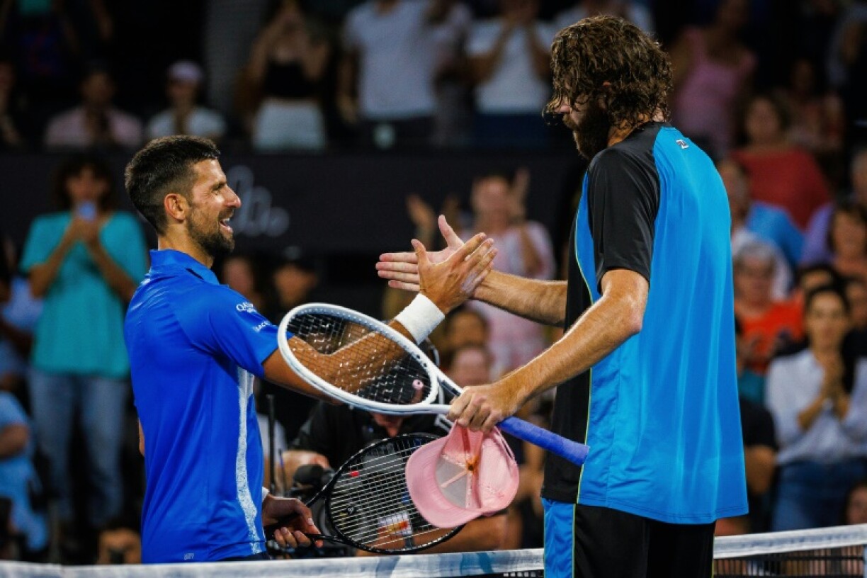 American Reilly Opelka (right) shakes hands with Serbia's Novak Djokovic after beating him in the quarter finals of the Brisbane International