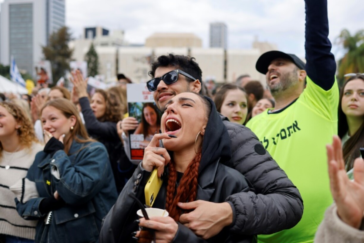 Members of a crowd gathered in Tel Aviv react during the livestreamed release of four women soldiers held hostage in Gaza