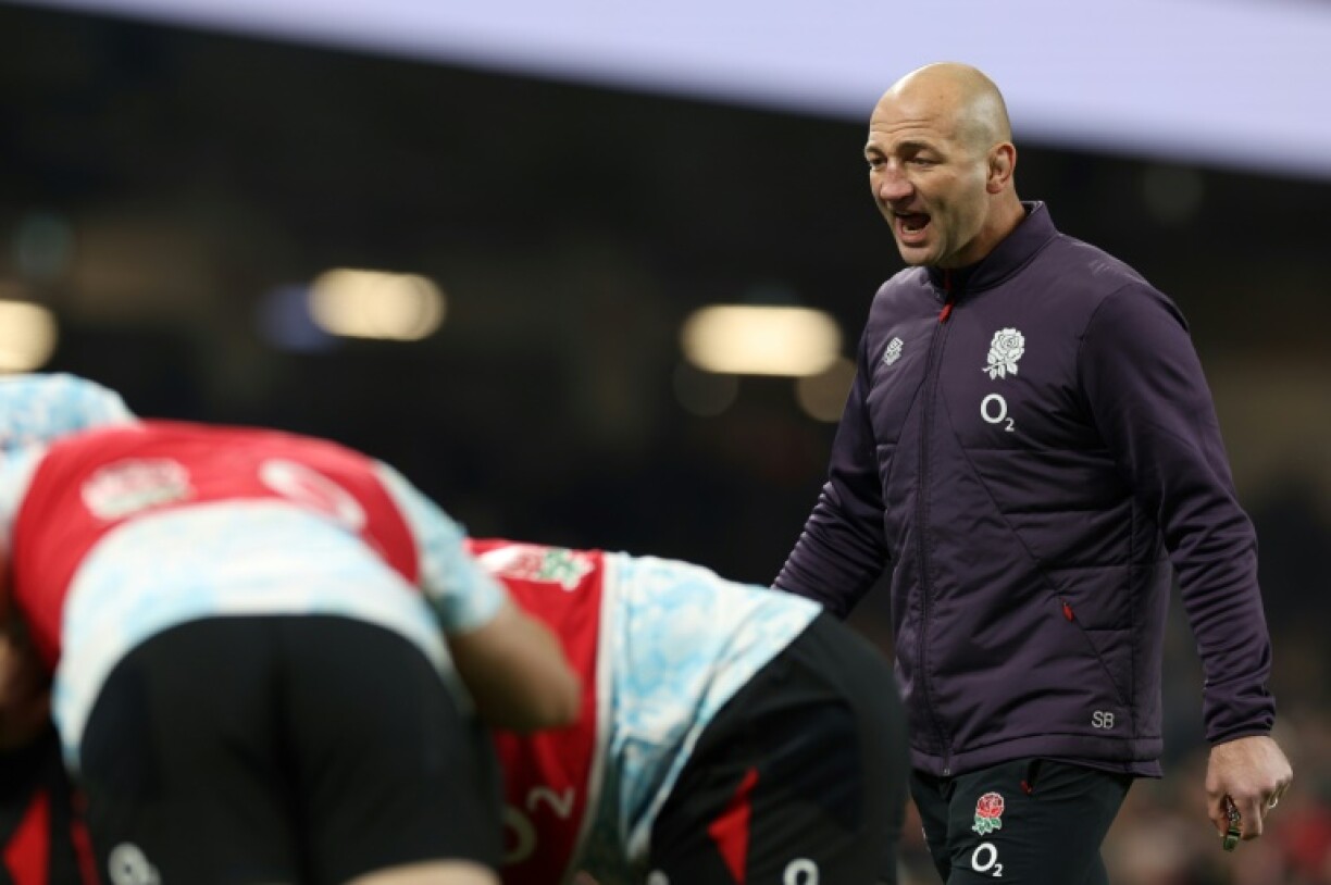 England's coach Steve Borthwick (R) watches his players warm up before their 68-14 Six Nations thrashing of Wales in Cardiff