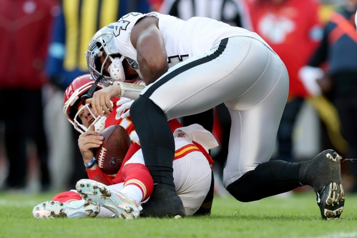 Kansas City quarterback Patrick Mahomes is sacked by K'Lavon Chaisson of the Las Vegas Raiders in the Chiefs' 19-17 NFL victory over the Raiders