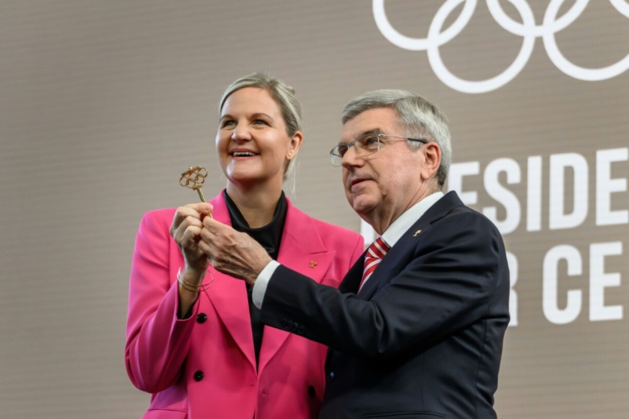 International Olympic Committee President Kirsty Coventry receives the ceremonial key from outgoing IOC President Thomas Bach during the handover ceremony