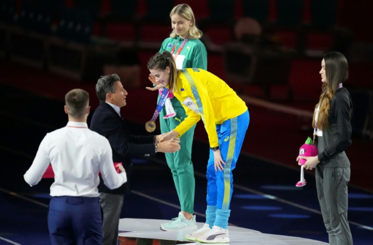 Sebastian Coe (2nd L), with Ukrainian high jump star Yaroslava Mahuchikh, was deeply marked by a visit to her war-wracked country