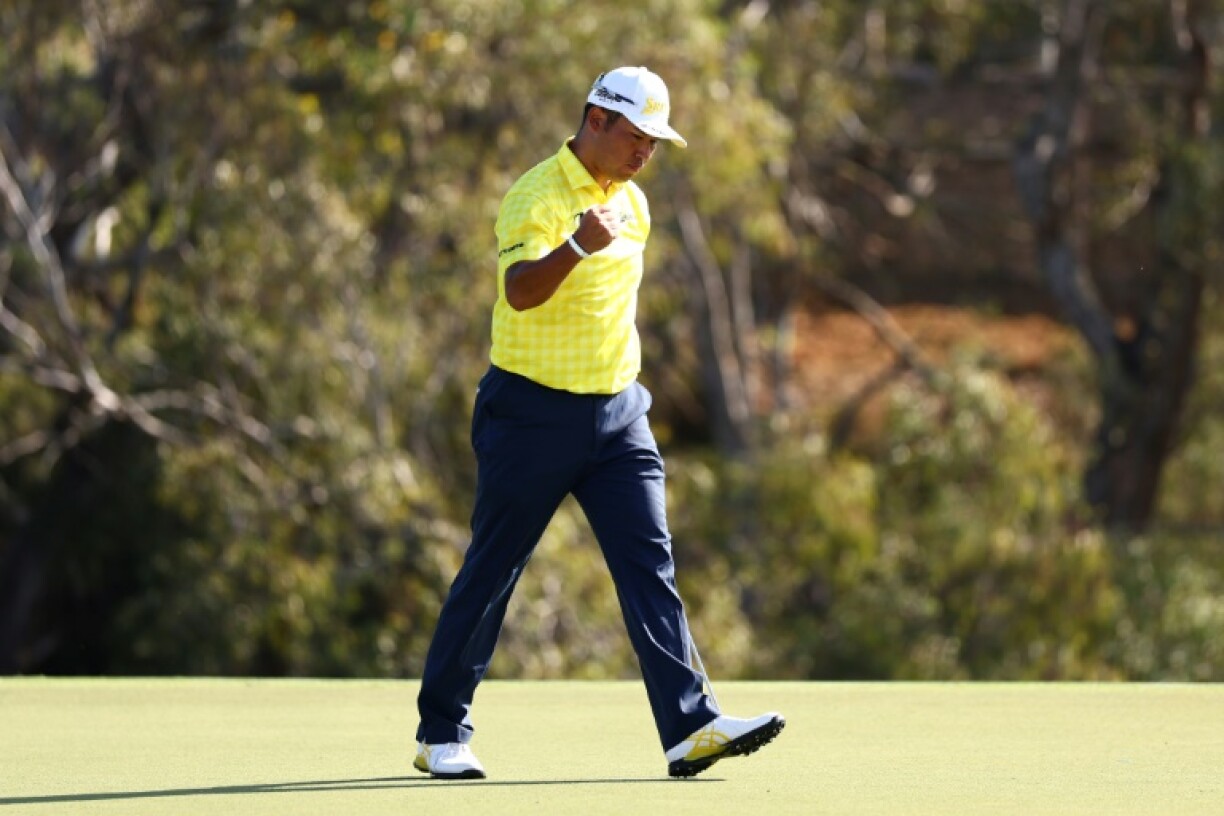Hideki Matsuyama of Japan celebrates on the 18th green after making a birdie putt to win The Sentry tournament and break the PGA Tour 72-hole low scoring record