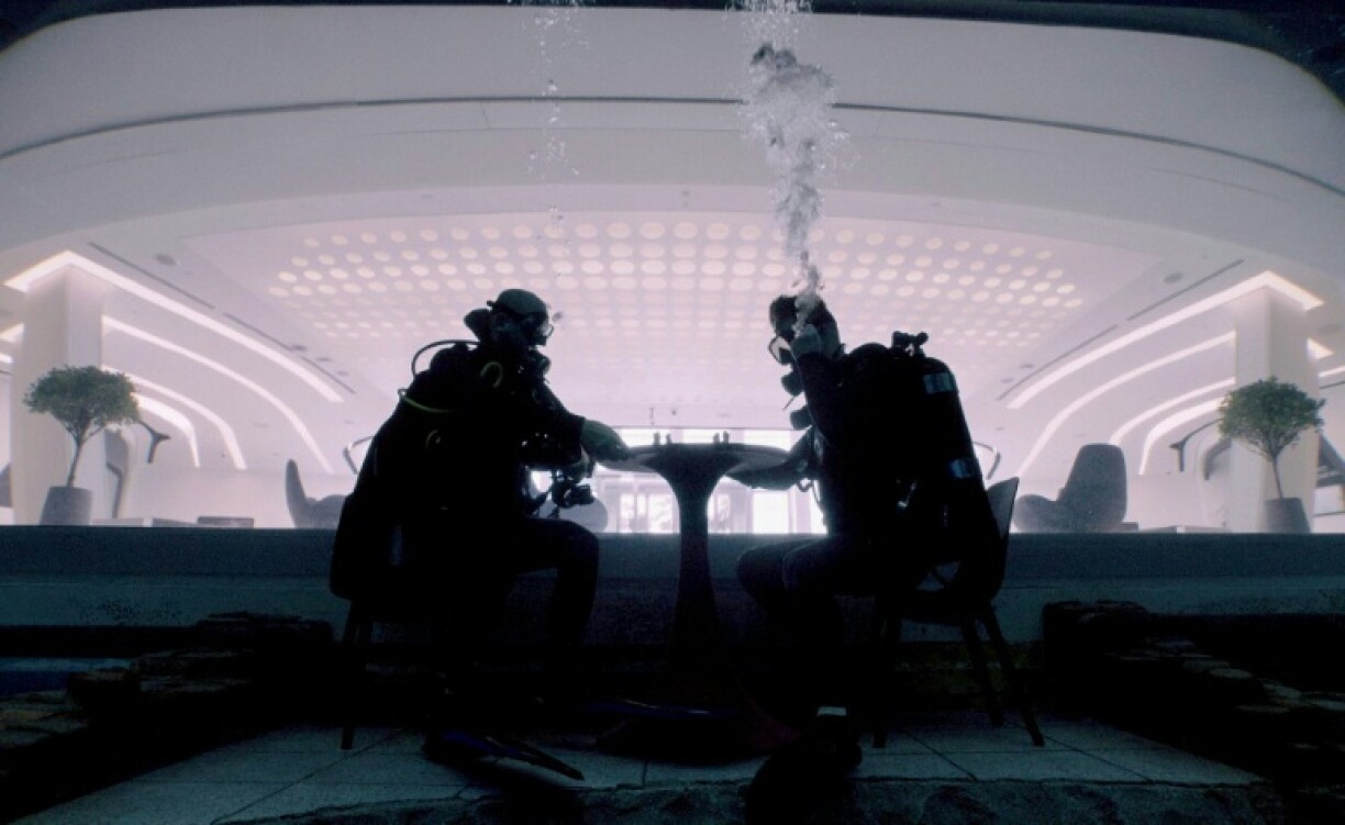 Divers play mock chess while experiencing Deep Dive Dubai