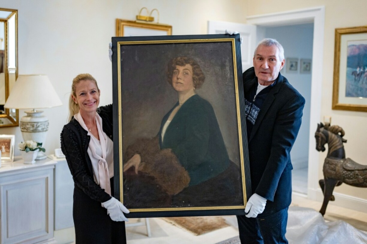The long-lost oil painting of Madam Kitty Schmidt, shown by authors Urs Brunner and Julia Schrammel