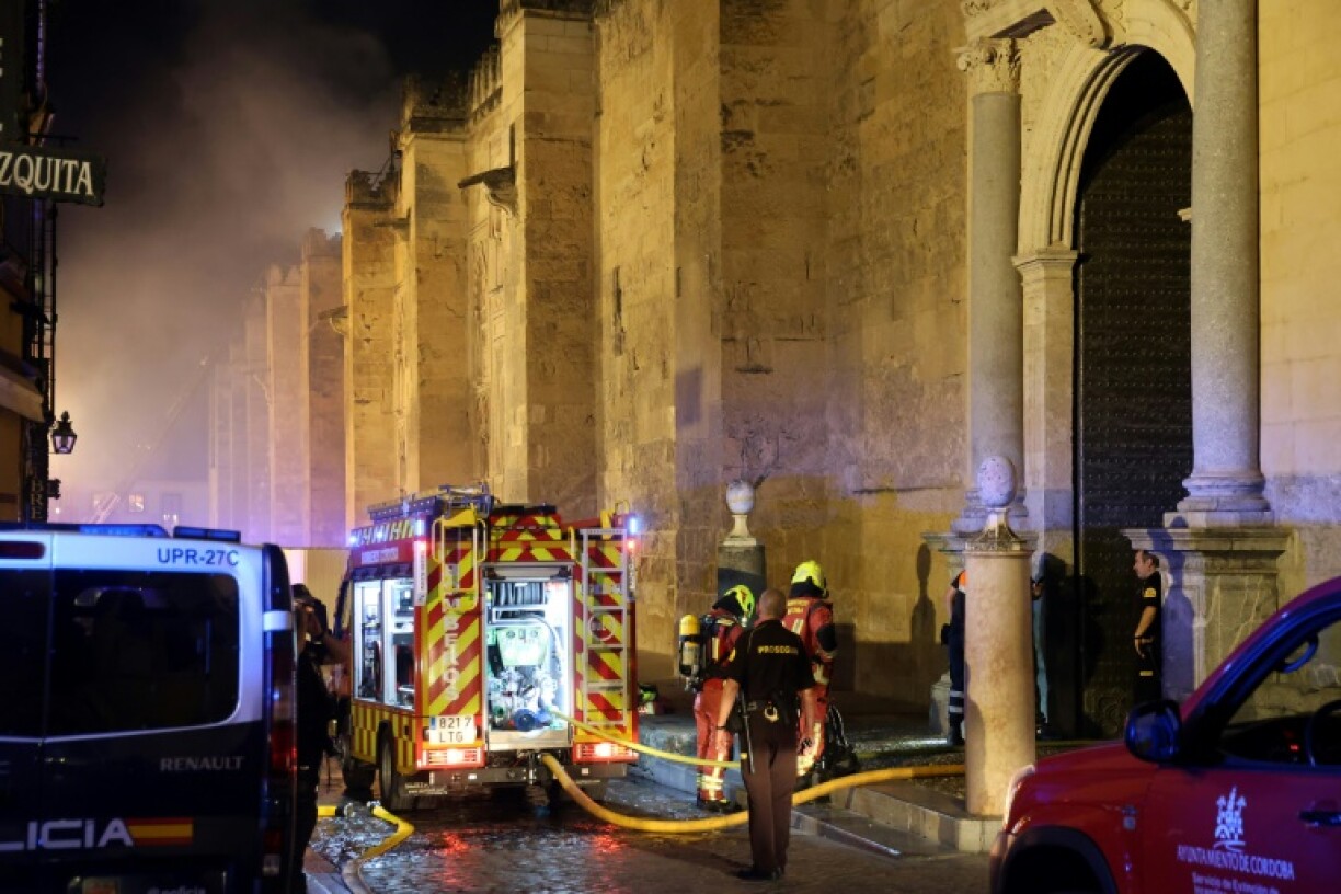 Firefighters work to extinguish a fire in the historic mosque-turned-cathedral in the southern Spanish city of Cordoba