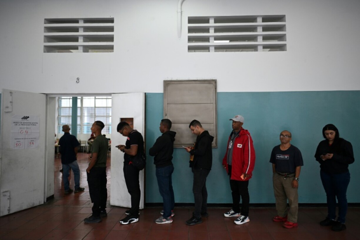 People queue before voting in Caracas