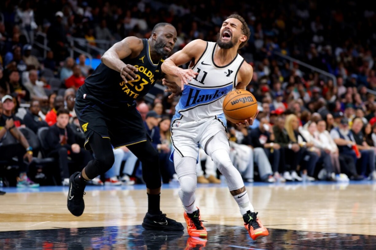 Trae Young of the Atlanta Hawks battles Draymond Green in the Hawks' NBA victory over the Golden State Warriors