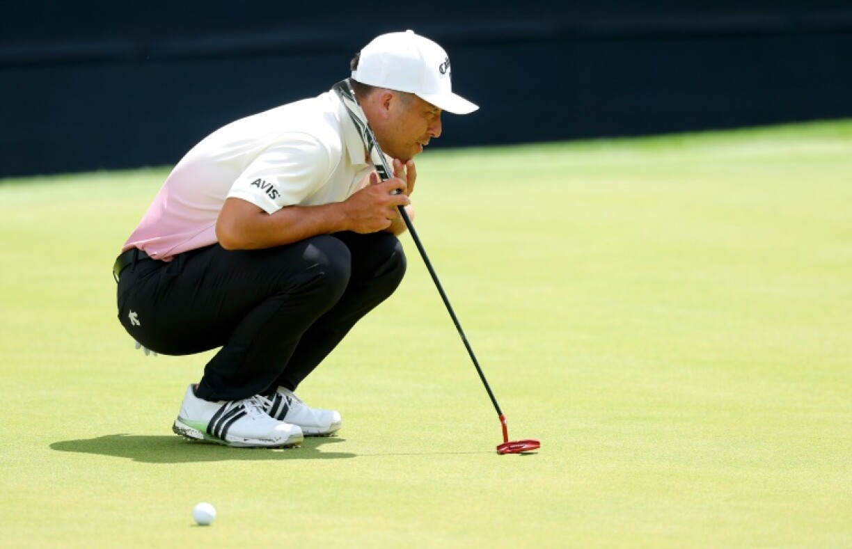 Defending champion Xander Schauffele lines up a putt on the tricky greens of Quail Hollow during a practice round for the 107th PGA Championship