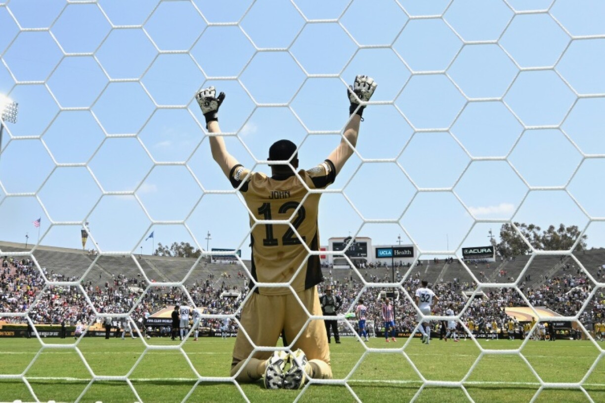 Botafogo goalkeeper John celebrates after the Brazilians advance to the last 16 of the Club World Cup despite a 1-0 defeat to Atletico Madrid