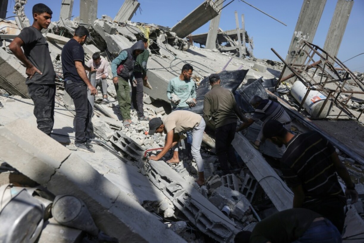 Palestinians sift through the rubble after a strike on northern Gaza's Jabalia