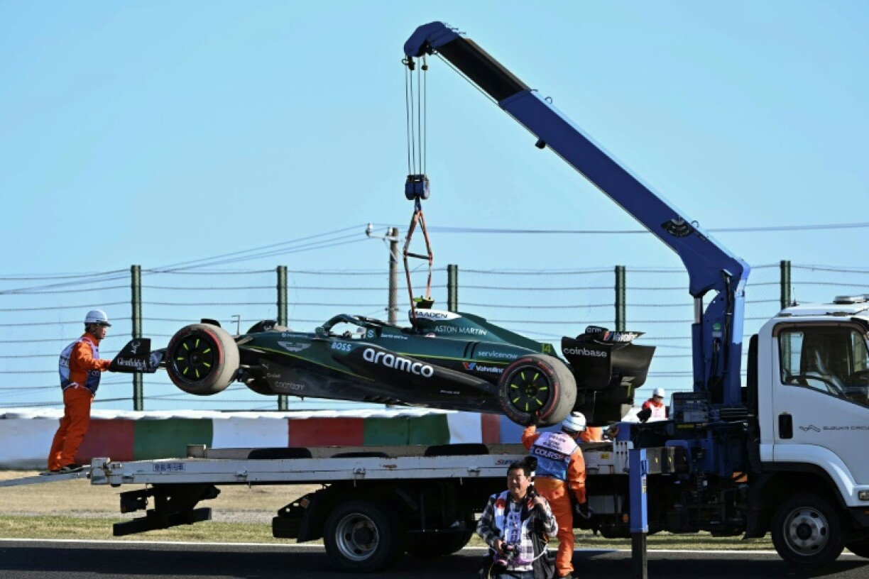 A truck transports the car of Aston Martin's Spanish driver Fernando Alonso