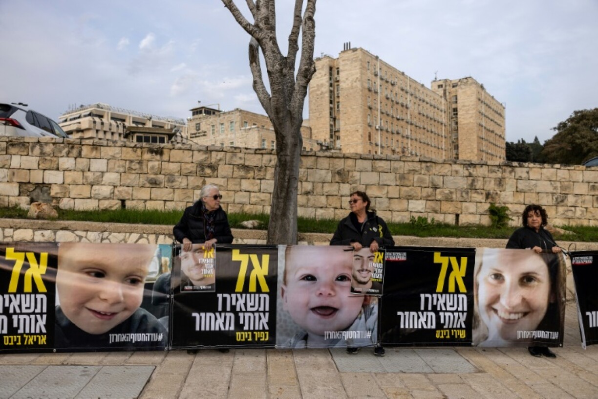 Portraits of Shiri Bibas and her children Ariel and Kfir, all Israeli hostages in Gaza, at a rally outside the prime minister's office in Jerusalem