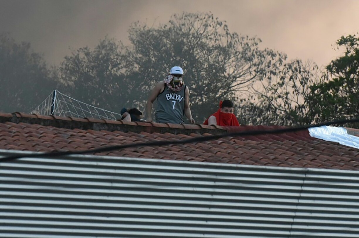 Des prisonniers sur le toit de la prison de Tacumbu à Asuncion, au Paraguay, pendant une mutinerie le 10 octobre 2023