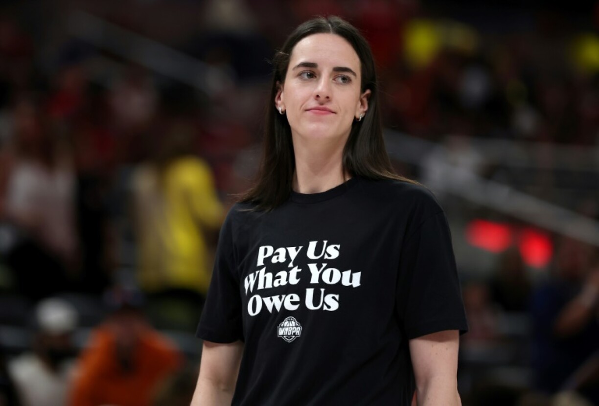 WNBA star Caitlin Clark of the Indiana Fever wears a T-shirt saying,