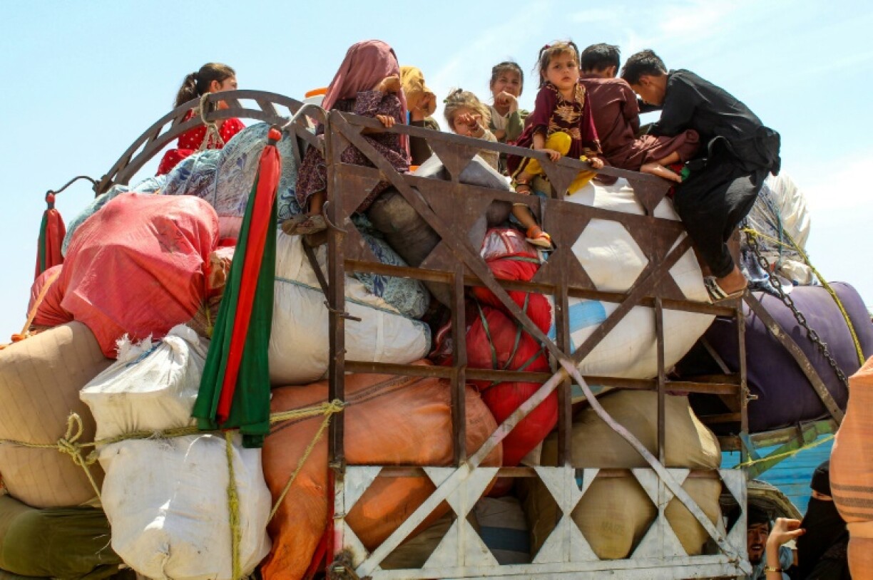 Afghan refugee children board a truck loaded with their belongings as they wait for their deportation to Afghanistan, at a holding centre near the Pakistan-Afghanistan border in Chaman on April 15, 2025