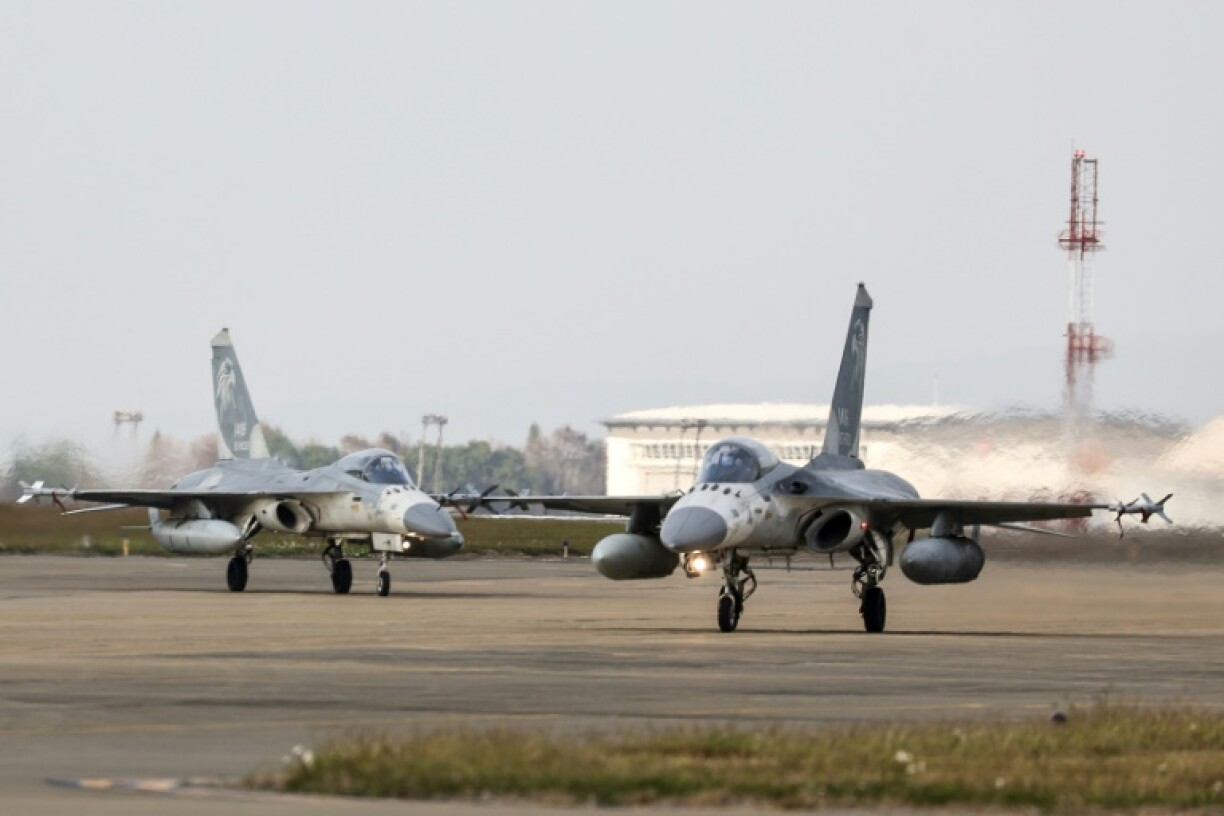 Taiwanese air force Indigenous Defense Fighter aircraft taxi for take-off during a scramble as part of a combat readiness exercise at an air base in Taichung in January